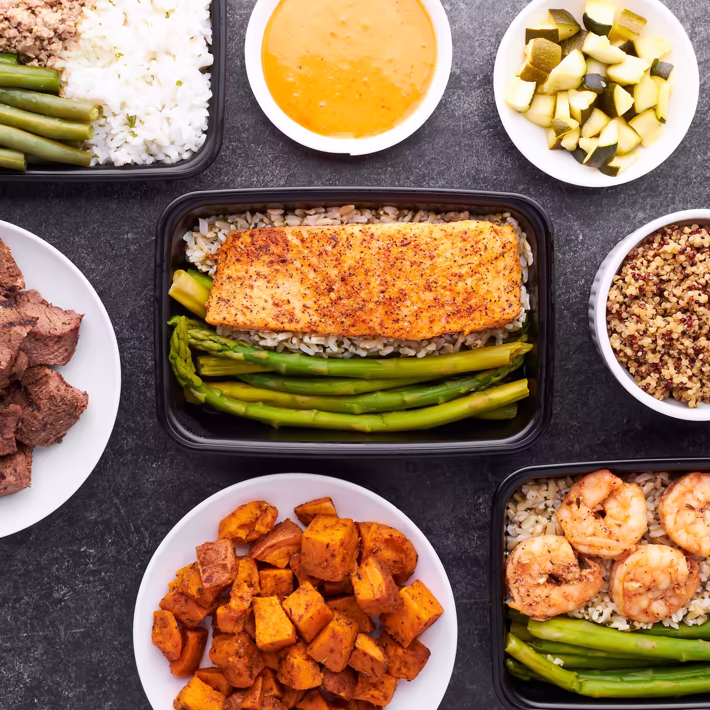 Prepared meals of salmon, asparagus, shrimp and sweet potato